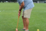 Man taking a shot at Croquet about to hit the ball through a wicket at Croquet on the Green 2019