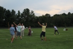 Winners of croquet final match throwing their hands into the air while losers have thrown their mallets aside as Walt Adam announces the of the game at Croquet on the Green 2019