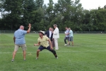 Two men high fiving on croquet field at Croquet on the Green 2019
