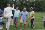 Two men high fiving with two other men laughing next to them at Croquet on the Green 2019