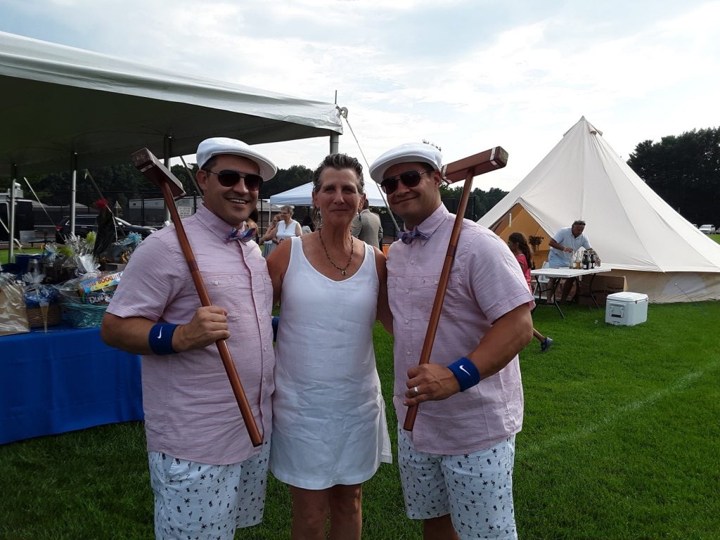 Woman with two men in matching croquet outfits at Croquet on the Green 2019
