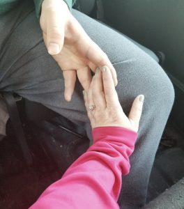 Woman's hand holding man's hand by finger tips