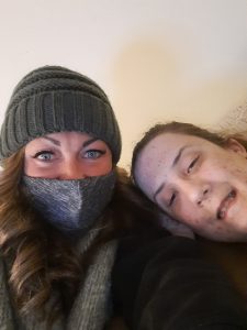 Woman with blue eyes and face mask with girl smiling