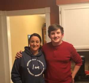 Tara Pleat in an I AM AIM hoodie with her son