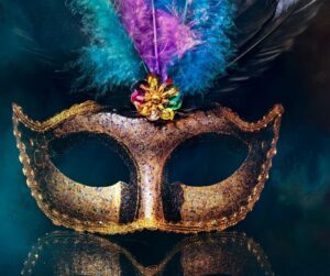 gold mask with purple blue and teal feathers