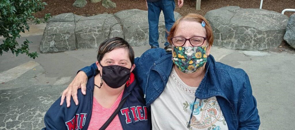 Emily with her friend Liz standing together wearing masks