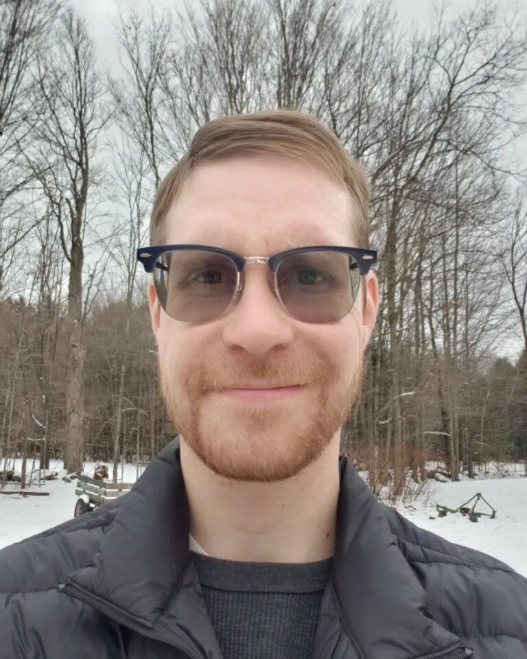 man outside in winter with sunglasses on