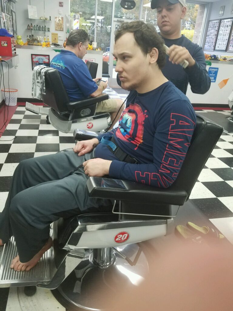 man getting his haircut by barber